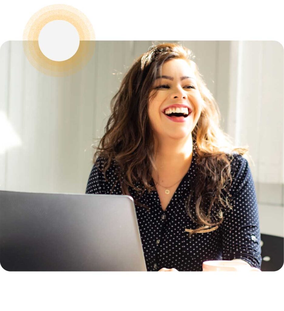 woman laughing while data security platform for e commerce companies on laptop