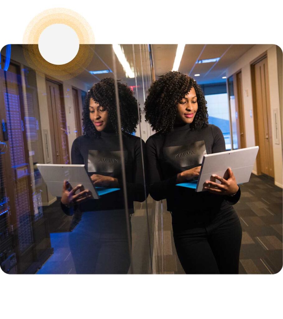 woman on laptop exploring Data Privacy Management Solution in hallway