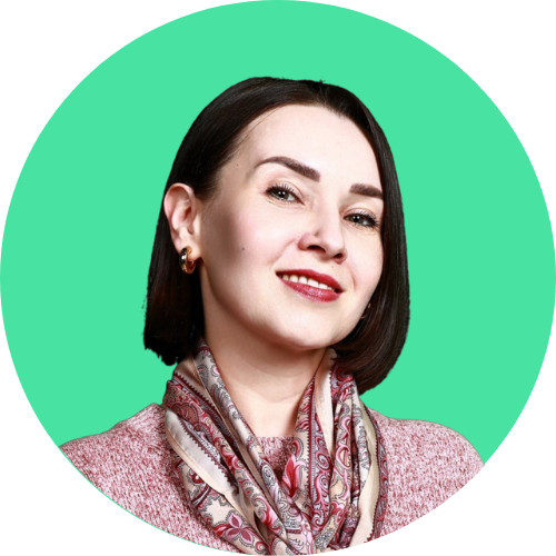 Smiling woman with short dark hair, wearing a patterned scarf and pink sweater, against a teal circular background.
